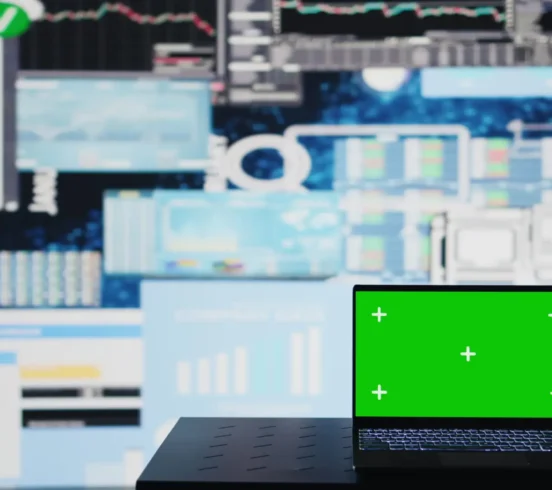 Isolated green screen on the laptop next to fintech monthly reports, ensuring a strategy for corporate success. Showcasing trends and infographics KPI metrics to improve activity. Camera B.